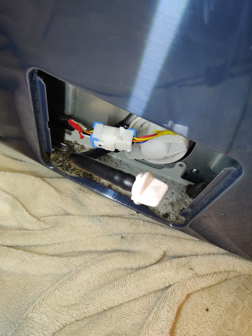 Opening the washer drain filter access: Samsung washer, model WF45K6200AZ (washer repair in Delray Beach, FL, September 2026)