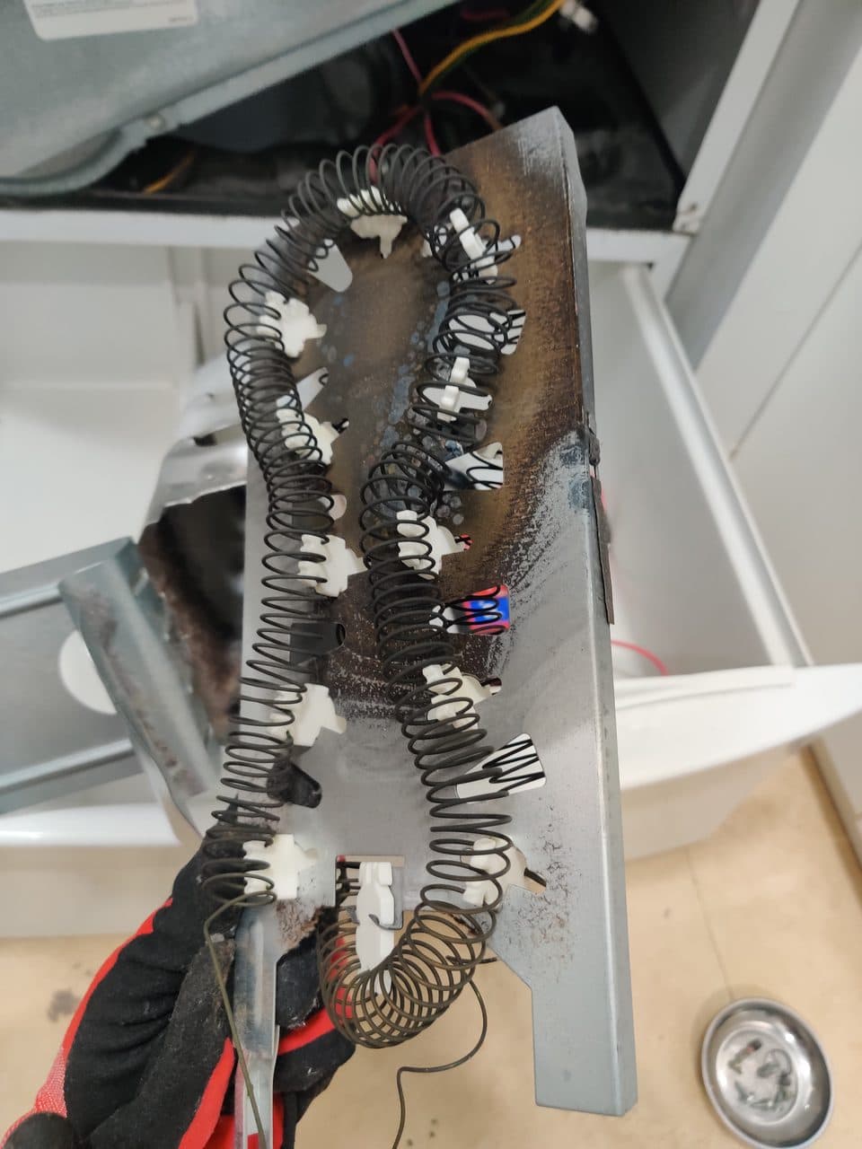 Old heating element removed: Kenmore dryer, model 110.64821301 (dryer repair in South Miami Heights, FL, August 2026)
